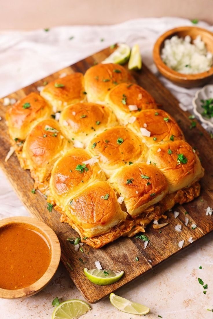 Pull-apart BBQ chicken sliders on Hawaiian rolls with melted cheese and golden garlic-butter tops