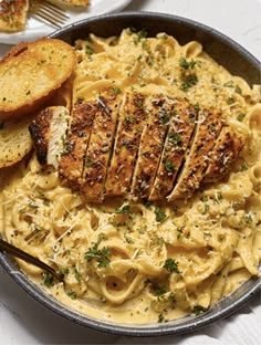 Slice of creamy chicken alfredo lasagna on a plate showing ricotta, chicken and melted cheese layers