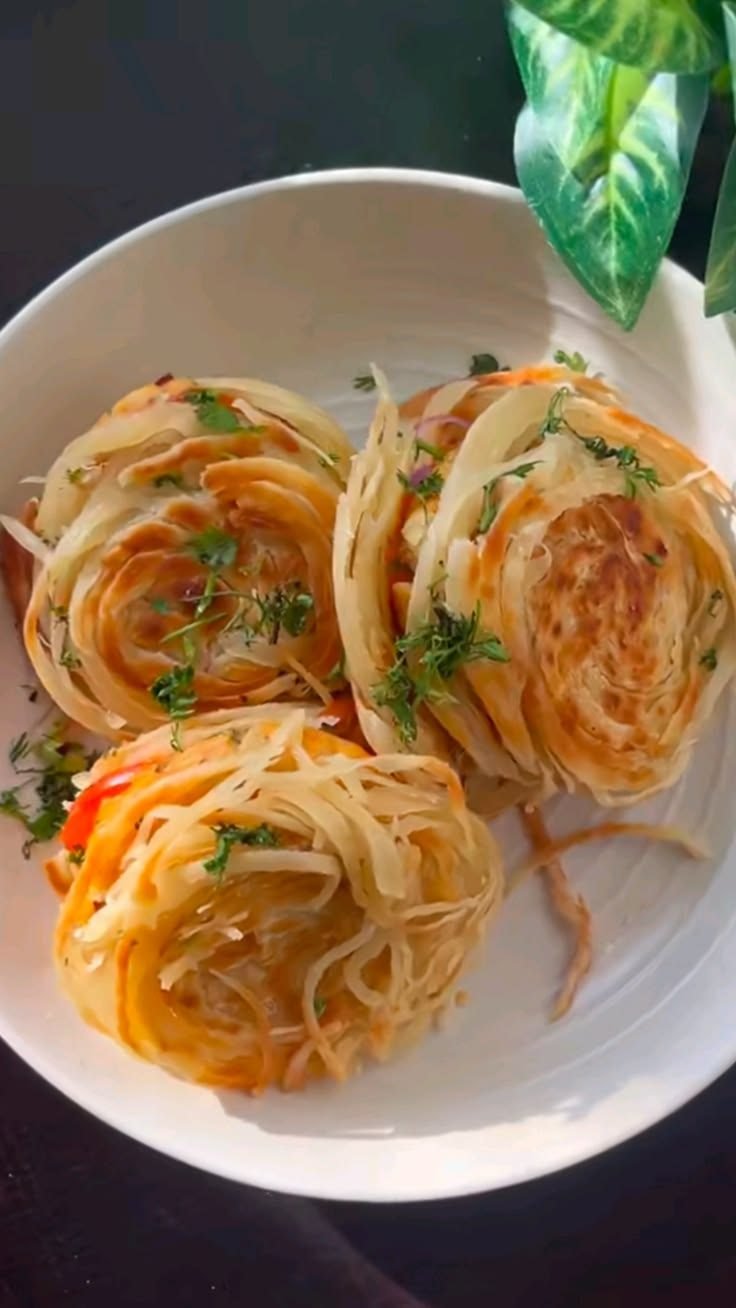 Dubai viral paratha cut in half, showing the smashed chicken patty, melted cheddar and onions